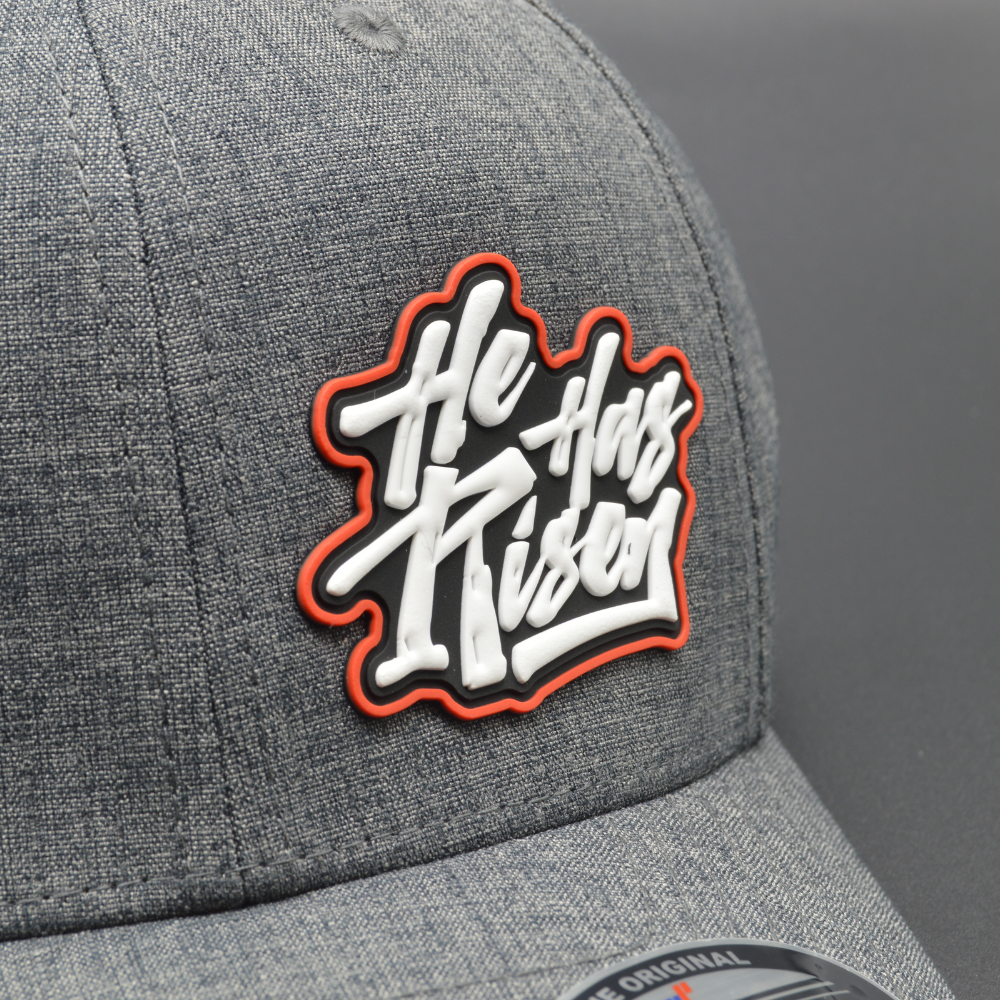 'HE HAS RISEN' FLEXFIT®  HEATHERLIGHT™ CAP