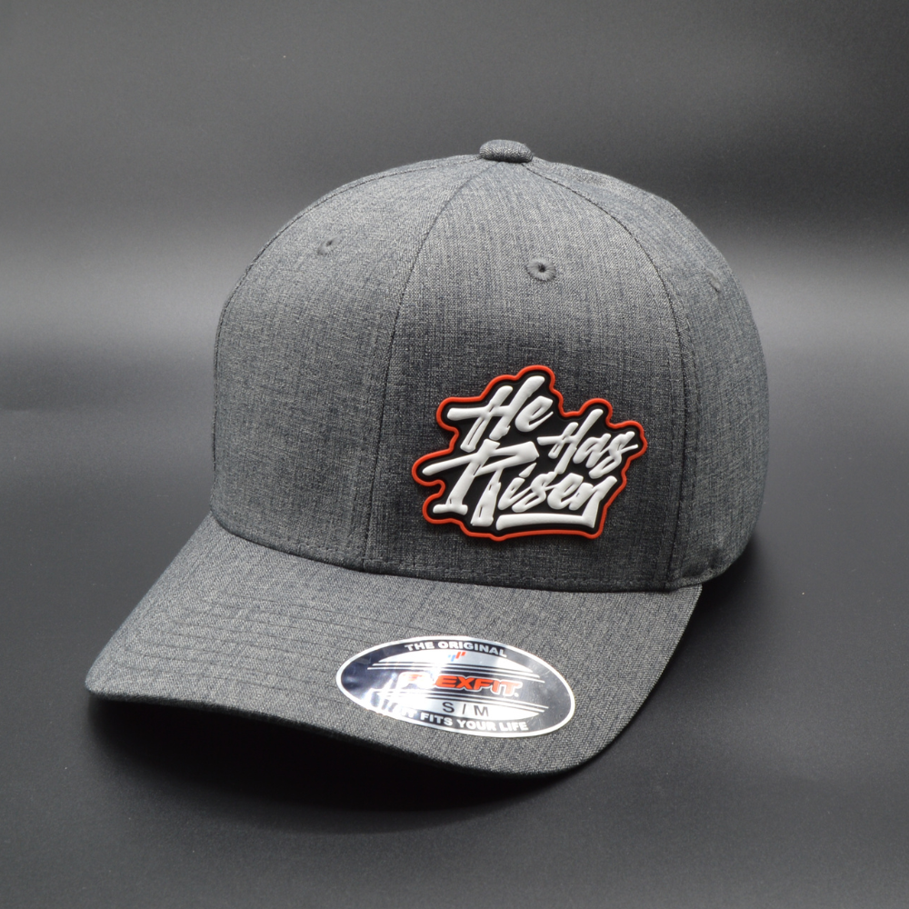 'HE HAS RISEN' FLEXFIT®  HEATHERLIGHT™ CAP