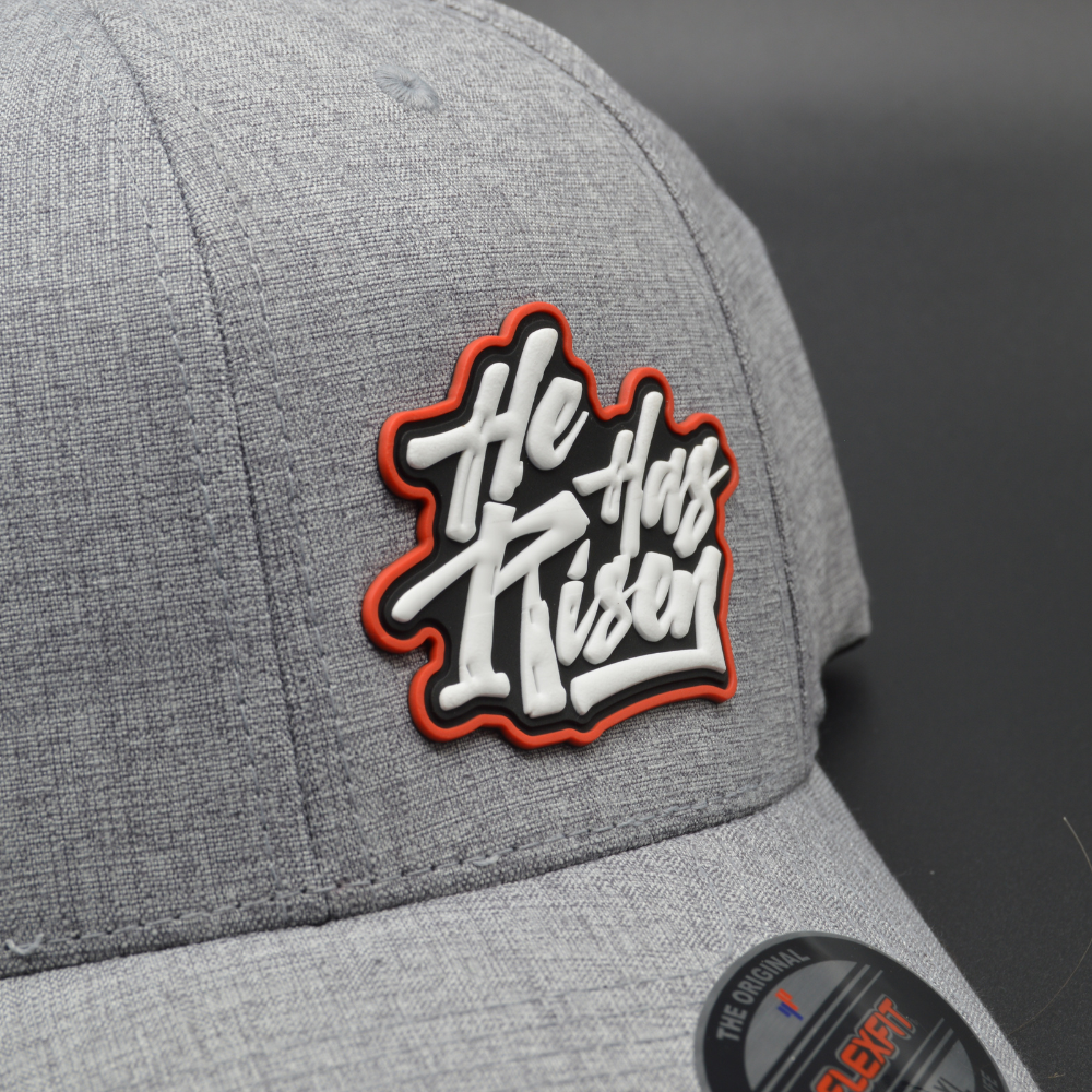 'HE HAS RISEN' FLEXFIT®  HEATHERLIGHT™ CAP