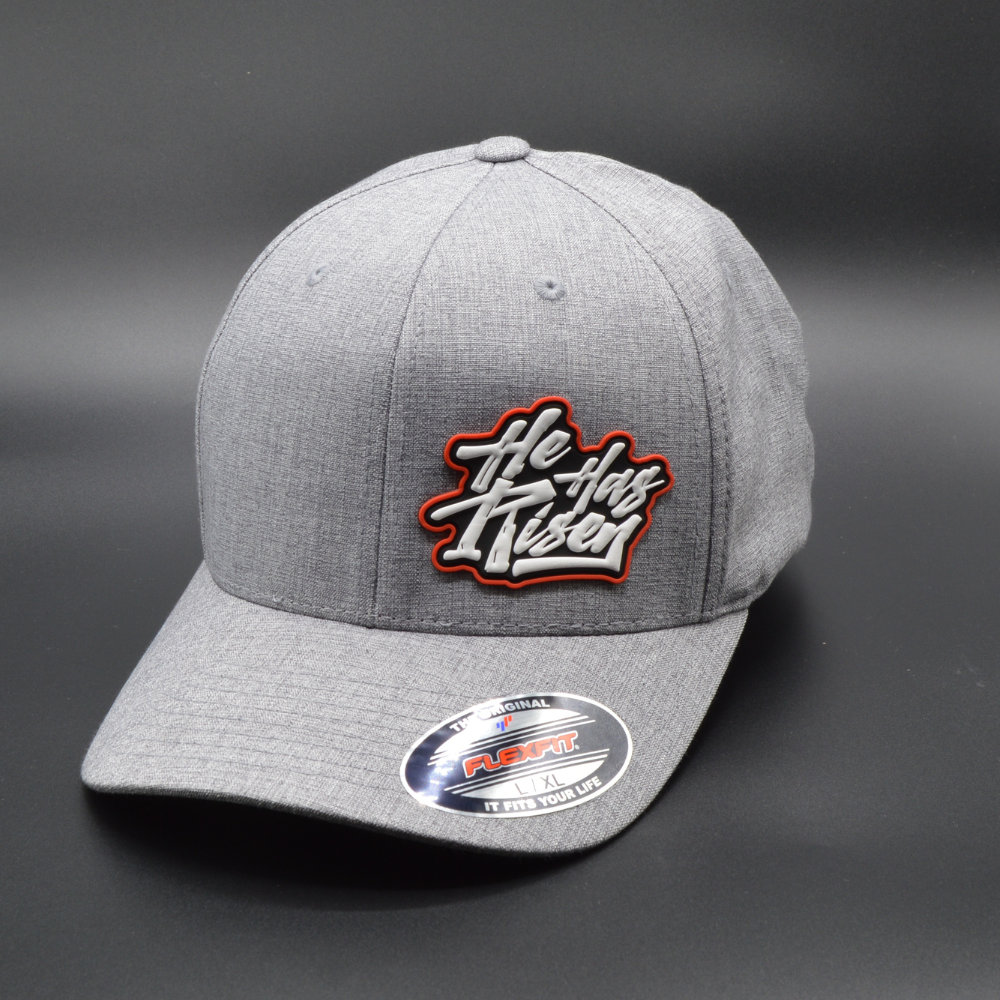 'HE HAS RISEN' FLEXFIT®  HEATHERLIGHT™ CAP