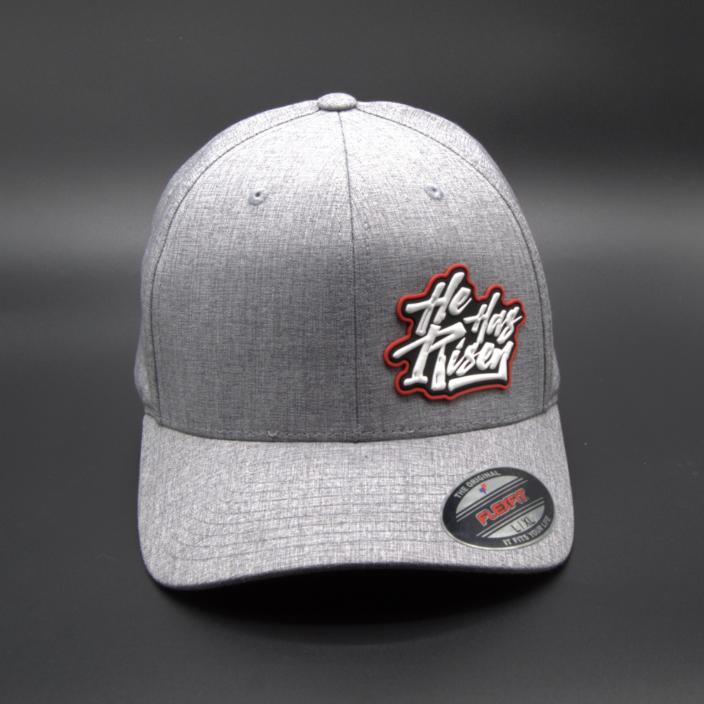'HE HAS RISEN' FLEXFIT®  HEATHERLIGHT™ CAP