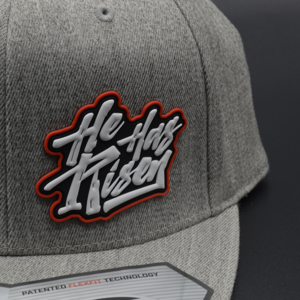 'HE HAS RISEN' FLEXFIT 110® PREMIUM SNAPBACK CAP