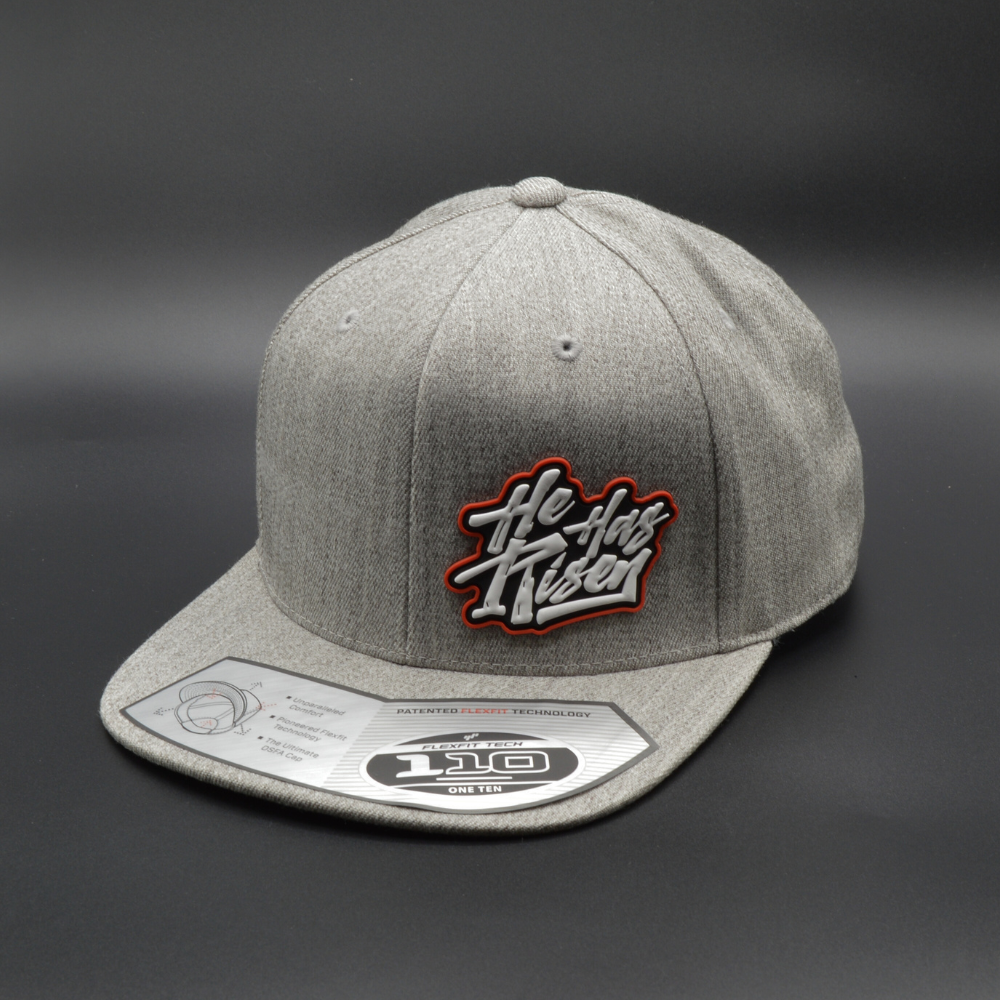 'HE HAS RISEN' FLEXFIT 110® PREMIUM SNAPBACK CAP